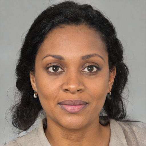 Joyful black young-adult female with medium  brown hair and brown eyes