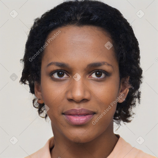 Joyful black young-adult female with short  black hair and brown eyes