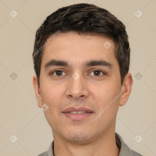 Joyful white young-adult male with short  black hair and brown eyes