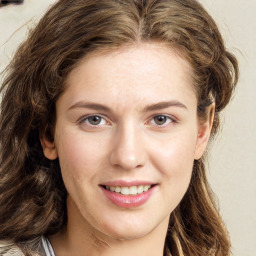 Joyful white young-adult female with long  brown hair and green eyes