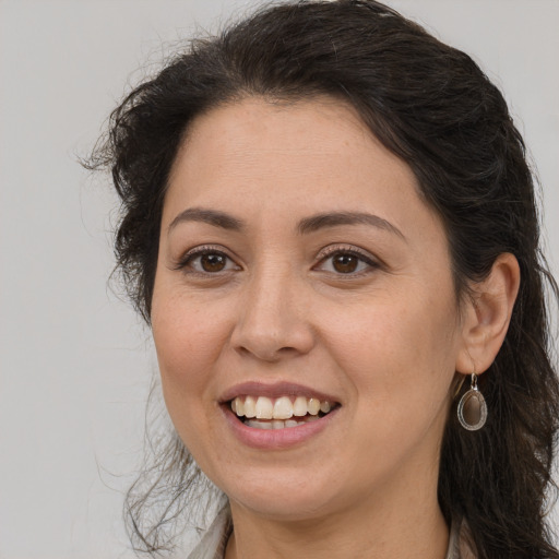 Joyful white adult female with long  brown hair and brown eyes