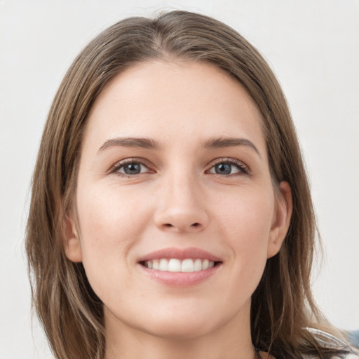 Joyful white young-adult female with long  brown hair and grey eyes