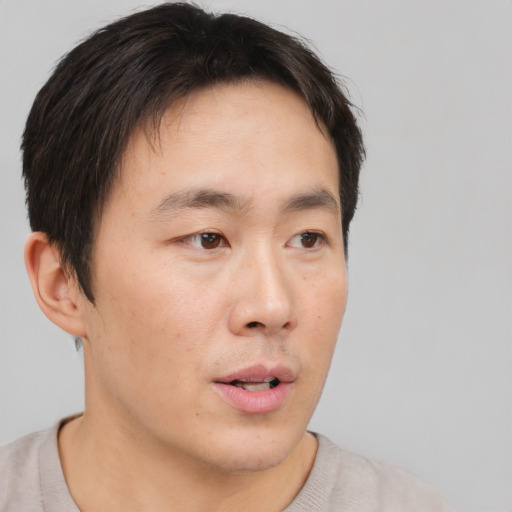 Neutral asian young-adult male with short  brown hair and brown eyes