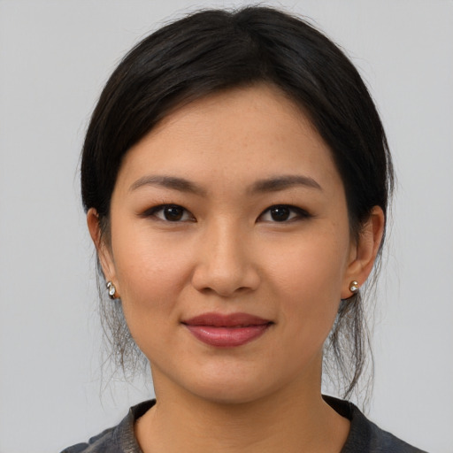 Joyful white young-adult female with medium  black hair and brown eyes