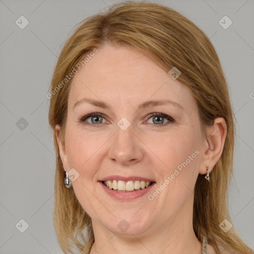 Joyful white adult female with medium  brown hair and grey eyes