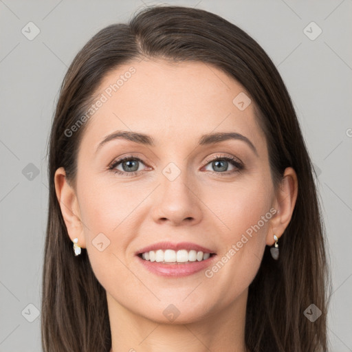 Joyful white young-adult female with long  brown hair and grey eyes