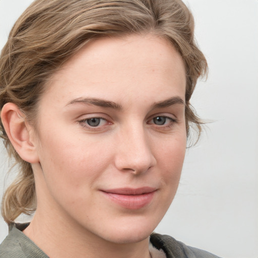 Joyful white young-adult female with medium  brown hair and blue eyes