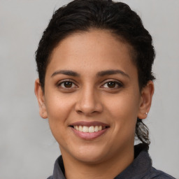 Joyful latino young-adult female with short  brown hair and brown eyes