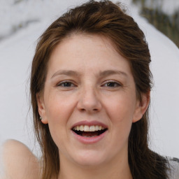 Joyful white adult female with medium  brown hair and brown eyes