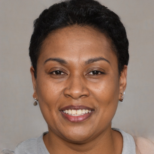 Joyful latino adult female with short  black hair and brown eyes