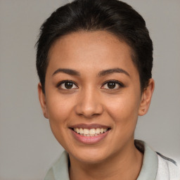 Joyful latino young-adult female with short  brown hair and brown eyes