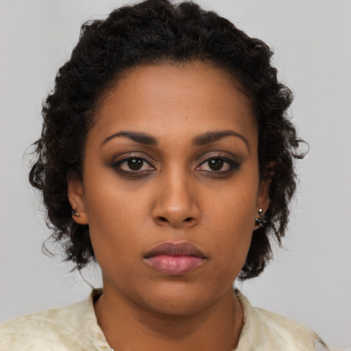 Neutral black young-adult female with medium  brown hair and brown eyes