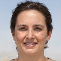 Joyful white adult female with short  brown hair and brown eyes