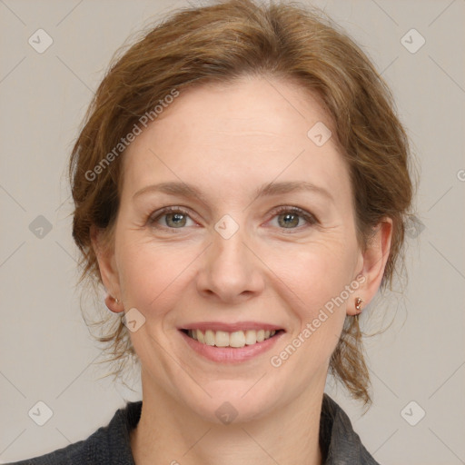 Joyful white adult female with medium  brown hair and grey eyes