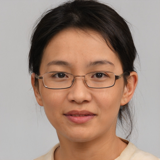 Joyful asian adult female with medium  brown hair and brown eyes