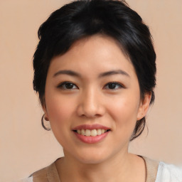 Joyful asian young-adult female with medium  black hair and brown eyes