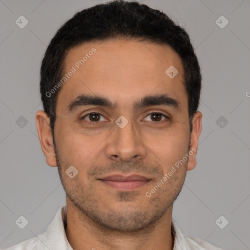 Joyful latino young-adult male with short  black hair and brown eyes