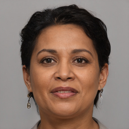 Joyful latino adult female with short  brown hair and brown eyes