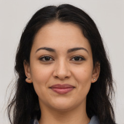 Joyful latino young-adult female with long  brown hair and brown eyes