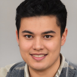 Joyful latino young-adult male with short  brown hair and brown eyes