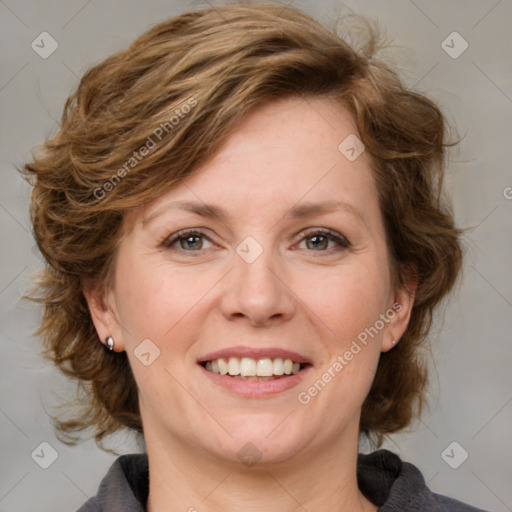 Joyful white adult female with medium  brown hair and blue eyes