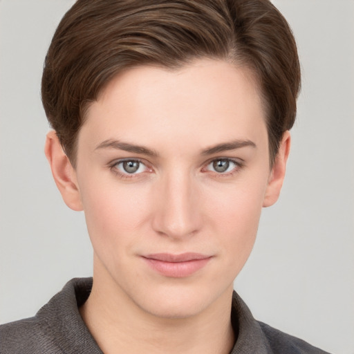 Joyful white young-adult female with short  brown hair and grey eyes