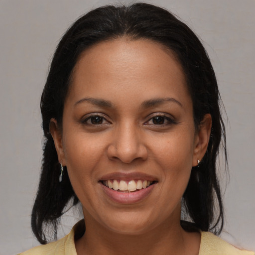 Joyful latino young-adult female with medium  brown hair and brown eyes