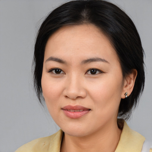 Joyful asian young-adult female with medium  black hair and brown eyes