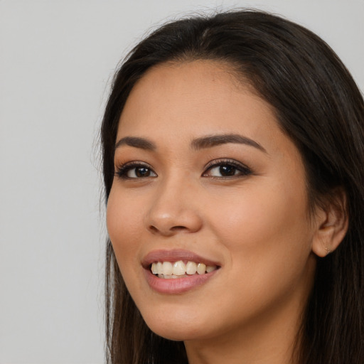 Joyful white young-adult female with long  brown hair and brown eyes