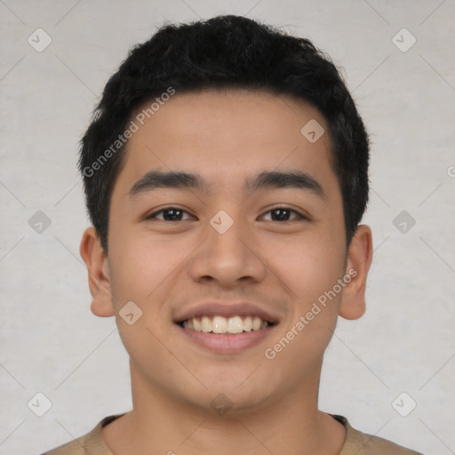 Joyful asian young-adult male with short  black hair and brown eyes