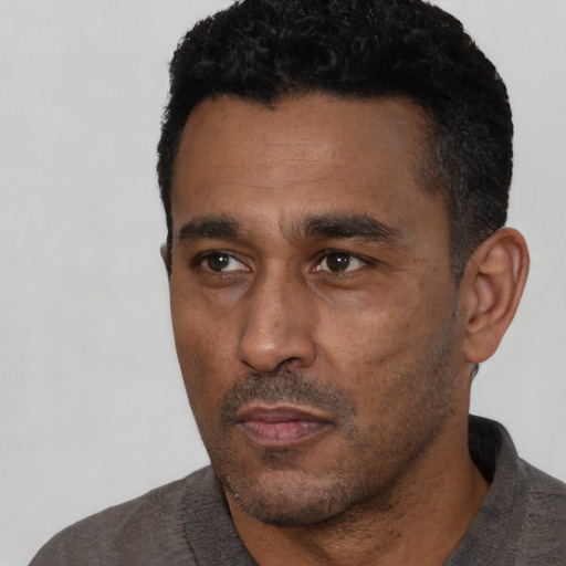 Neutral black adult male with short  black hair and brown eyes