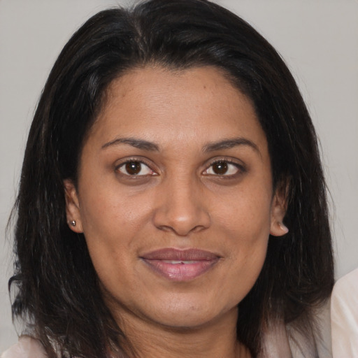 Joyful asian adult female with medium  brown hair and brown eyes