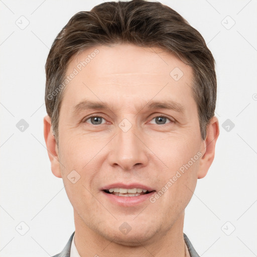 Joyful white adult male with short  brown hair and brown eyes