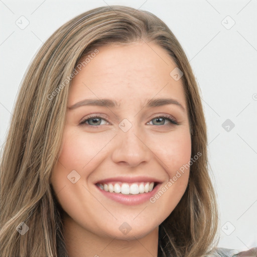 Joyful white young-adult female with long  brown hair and green eyes