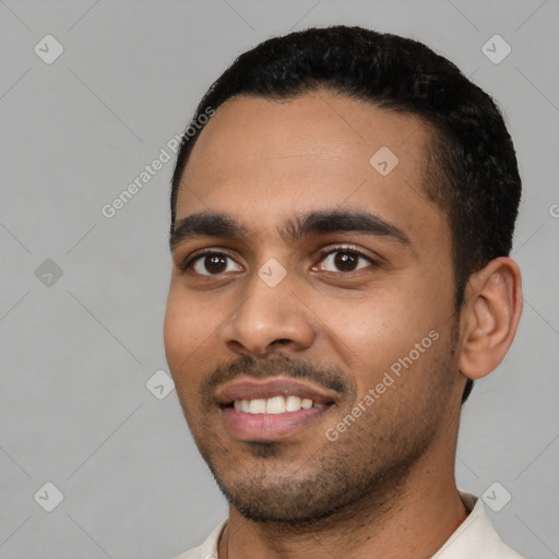 Joyful latino young-adult male with short  black hair and brown eyes