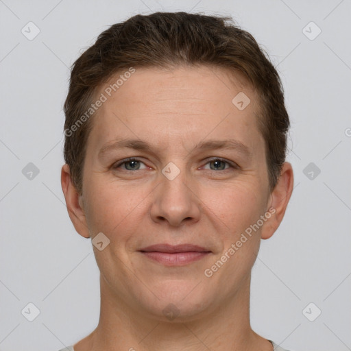 Joyful white adult female with short  brown hair and grey eyes