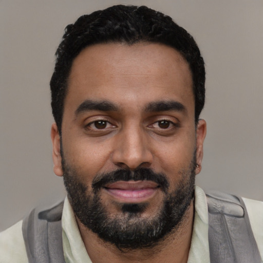 Joyful black young-adult male with short  black hair and brown eyes