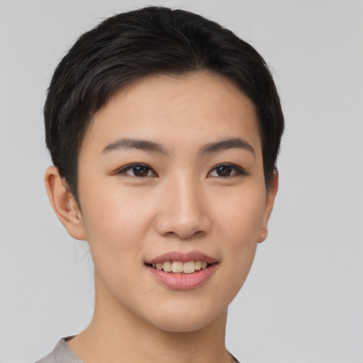 Joyful asian young-adult female with short  brown hair and brown eyes