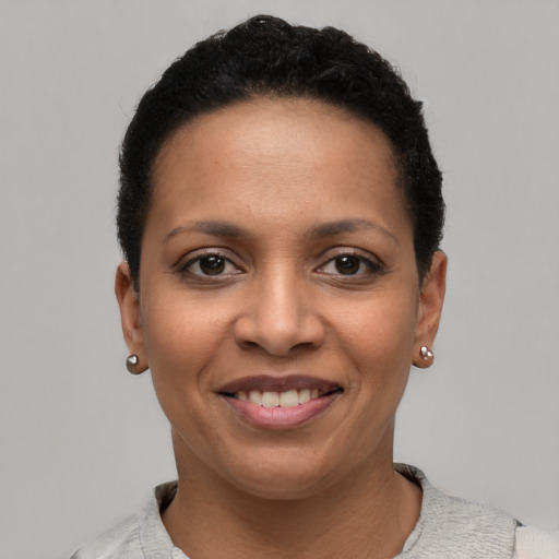 Joyful latino young-adult female with short  black hair and brown eyes