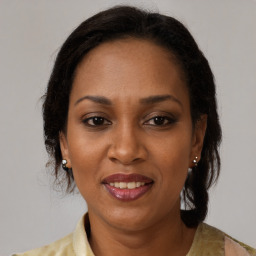 Joyful black adult female with medium  brown hair and brown eyes