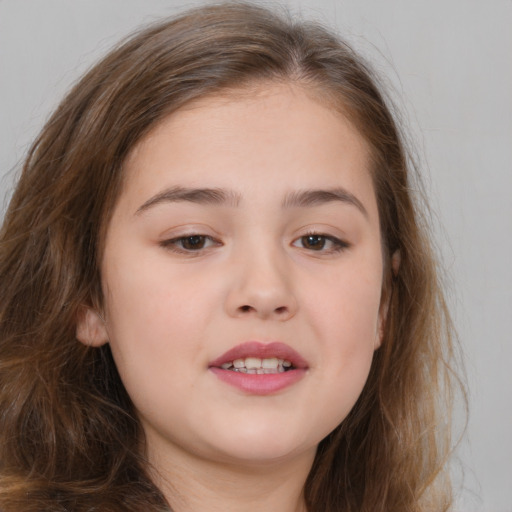 Joyful white child female with long  brown hair and brown eyes