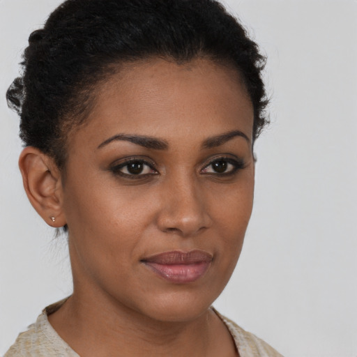 Joyful black young-adult female with short  brown hair and brown eyes