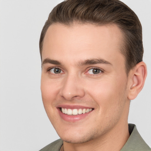 Joyful white young-adult male with short  brown hair and brown eyes