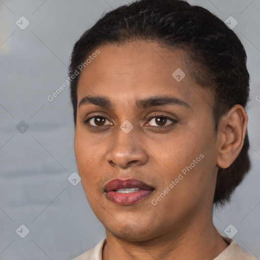 Joyful latino young-adult female with short  black hair and brown eyes