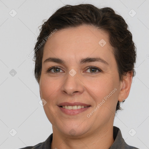 Joyful white adult female with short  brown hair and brown eyes