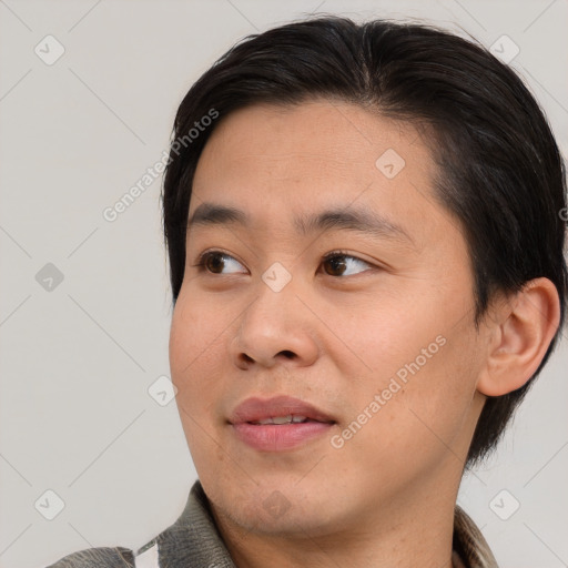 Joyful asian young-adult male with short  brown hair and brown eyes