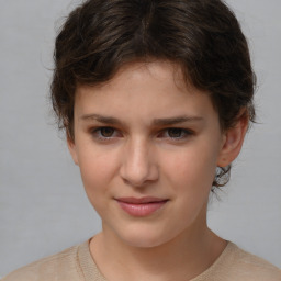 Joyful white child female with short  brown hair and brown eyes