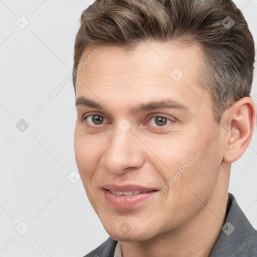 Joyful white adult male with short  brown hair and brown eyes