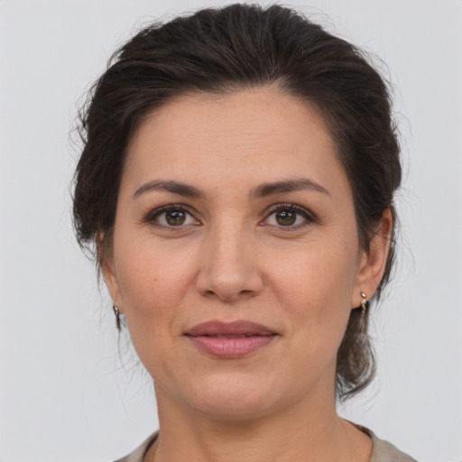 Joyful white adult female with medium  brown hair and brown eyes