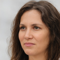 Joyful white adult female with long  brown hair and brown eyes